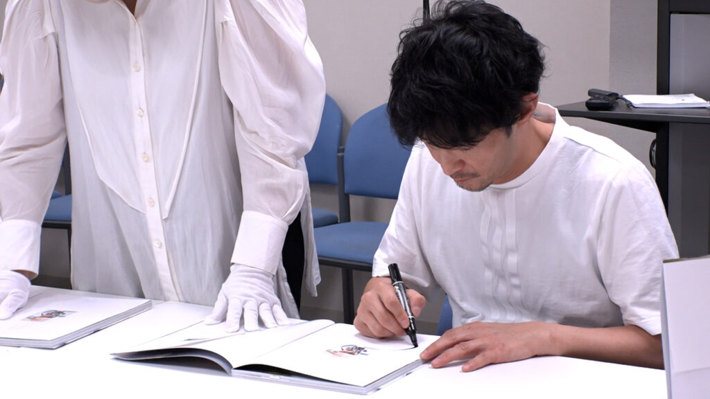 Kenjiro Tsuda ký tặng bản in cuốn sách ảnh “Whisper” của mình